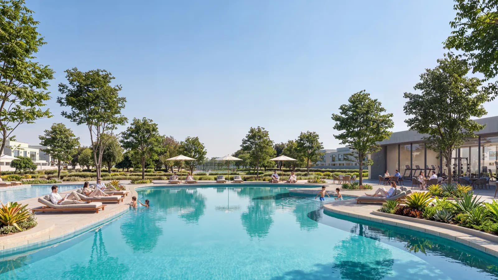 Clubhouse pool with loungers among palms and trees